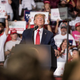 Donald Trump, with a smattering of “Latinos for Trump” signs behind him, speaks in New Mexico, a state he lost in 2016, during a campaign rally Sept. 16, 2019, at the Santa Ana Star Center in Rio Rancho, where he tried to enlist support from “the Hispanics” in his re-election efforts.